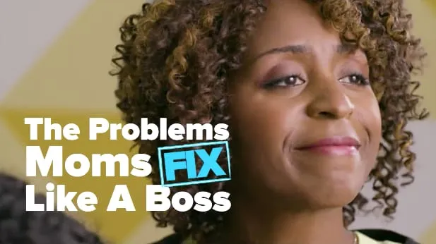 Still from the BuzzFeed Video featuring Sophia Thomas as the boss mom: a smiling curly-haired woman beside the text The Problems Moms FIX Like A Boss.