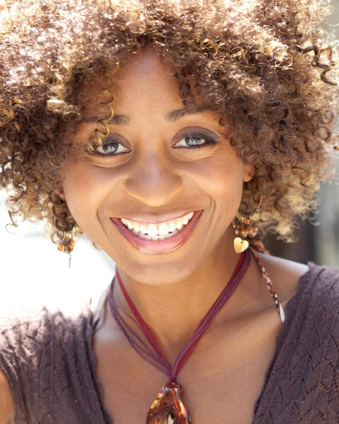 Sophia Thomas laughing on a sunlit Los Angeles street