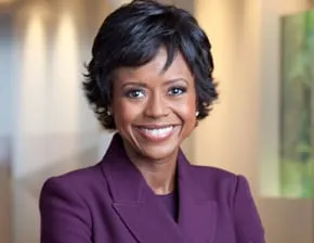 Portrait of a smiling woman with short dark hair in a purple blazer, shown with the announcement of the Mellody Hobson role