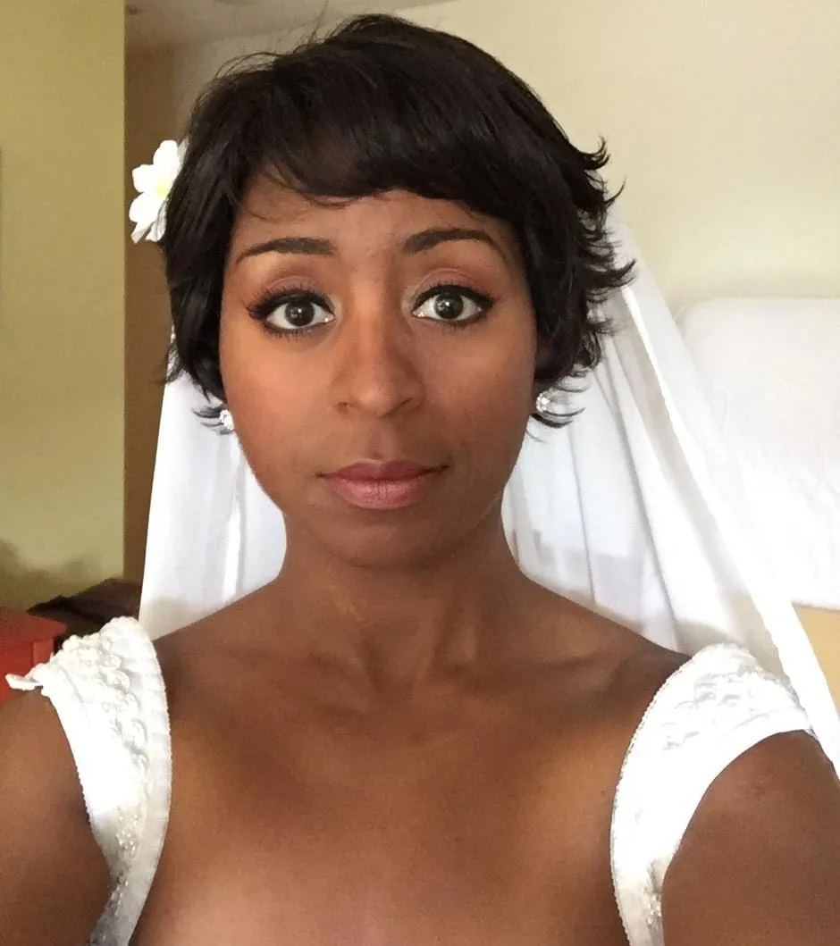 Sophia Thomas as Mellody Hobson in a still from the Star Trek Wars trailer: short dark hair, a white flower, a veil and a white beaded gown.