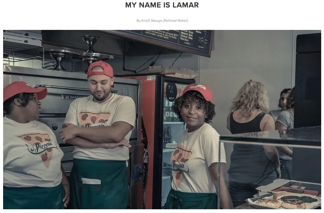 Sophia Thomas as Teresa with fellow pizzeria workers on the My Name Is Lamar set: three people in red caps, Pizzeria T-shirts and green aprons.