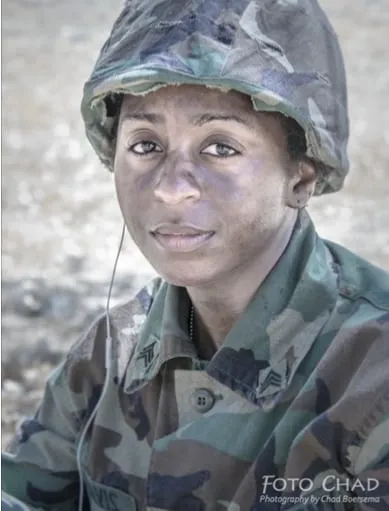 Sophia Thomas as Melanie Davis, a soldier in a camouflage helmet and fatigues, in No Place for Us (photo by Foto Chad)
